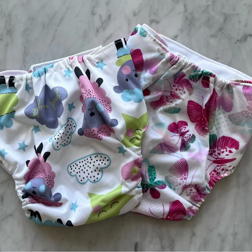 Adjustable, vinyl, disposable diapers with carry bag. Inserts bought separately.